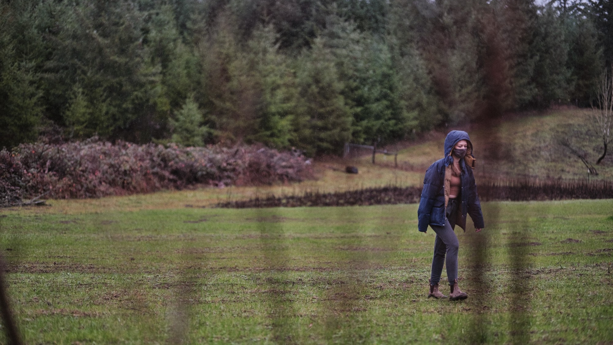 Image of a woman walking across a field.